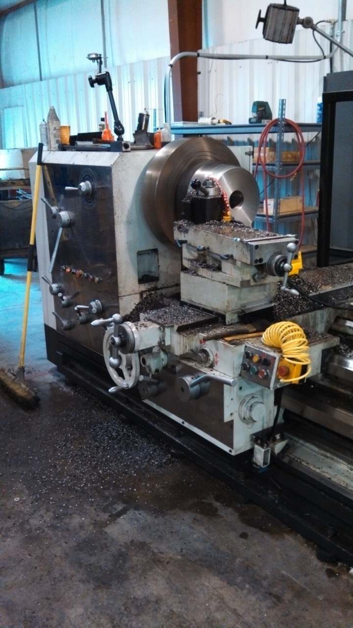 Close-up of lathe setup for custom hydraulic component machining