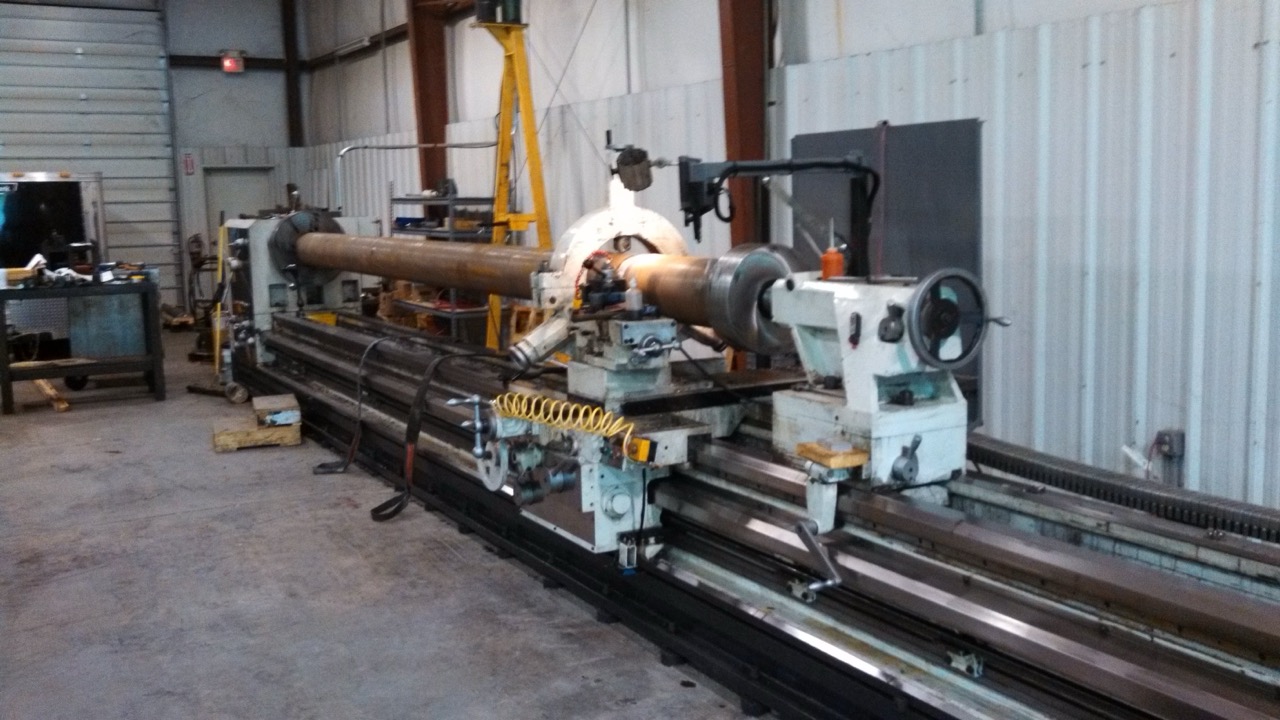 Large lathe machining a custom hydraulic cylinder component