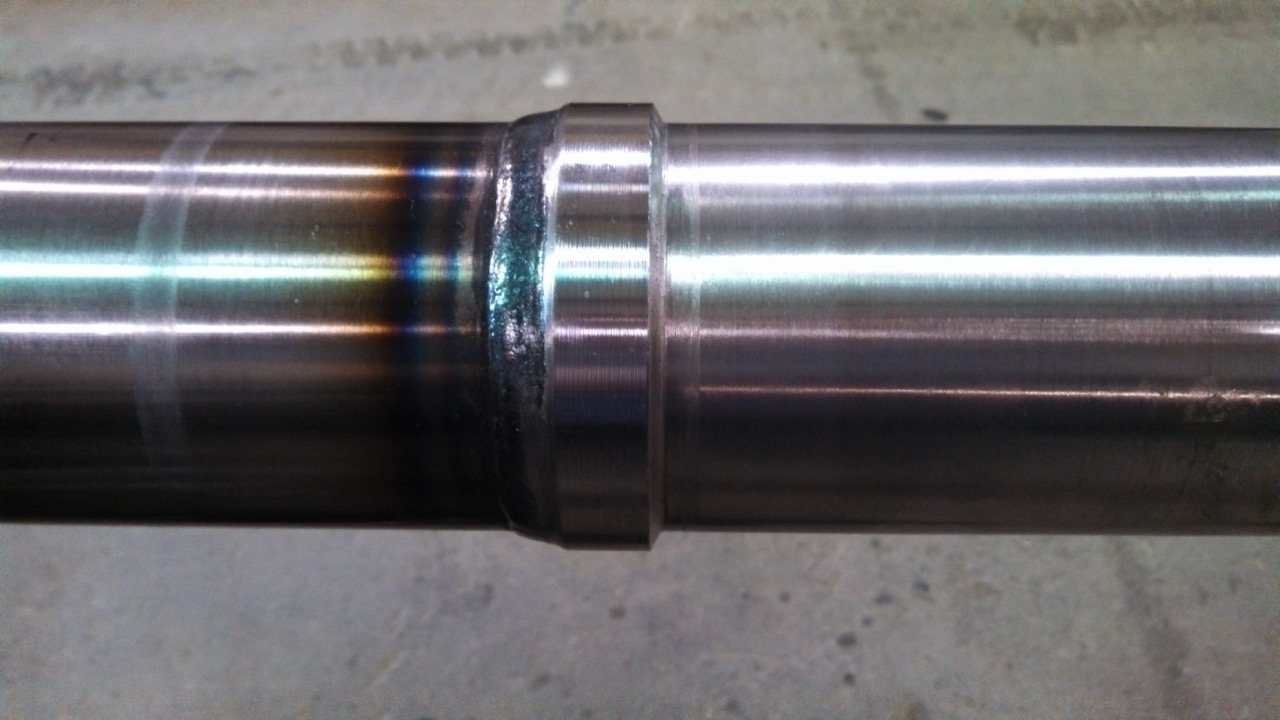 Stop feature welded onto telescopic cylinder component during custom modification