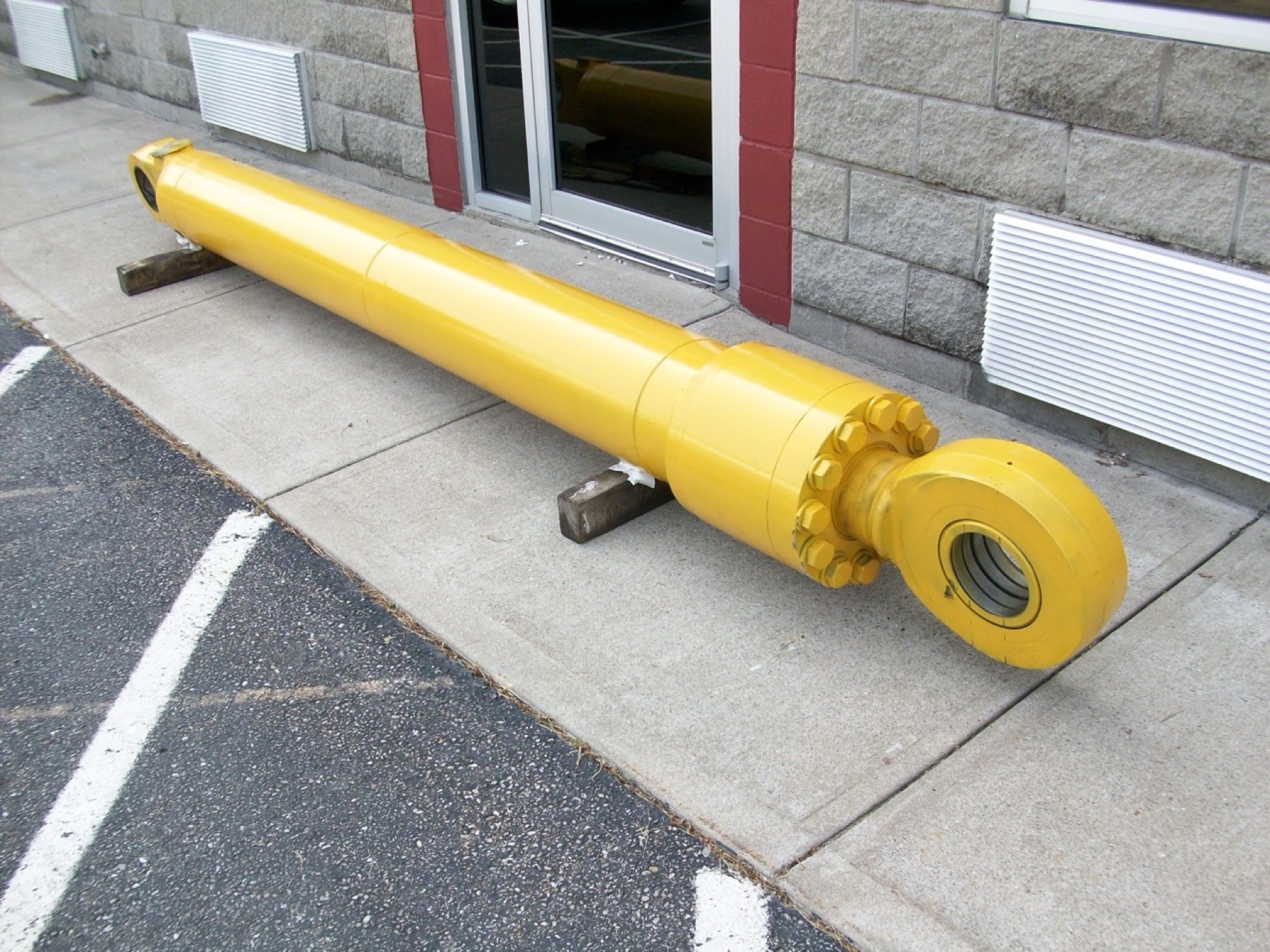 Large yellow Komatsu excavator cylinder