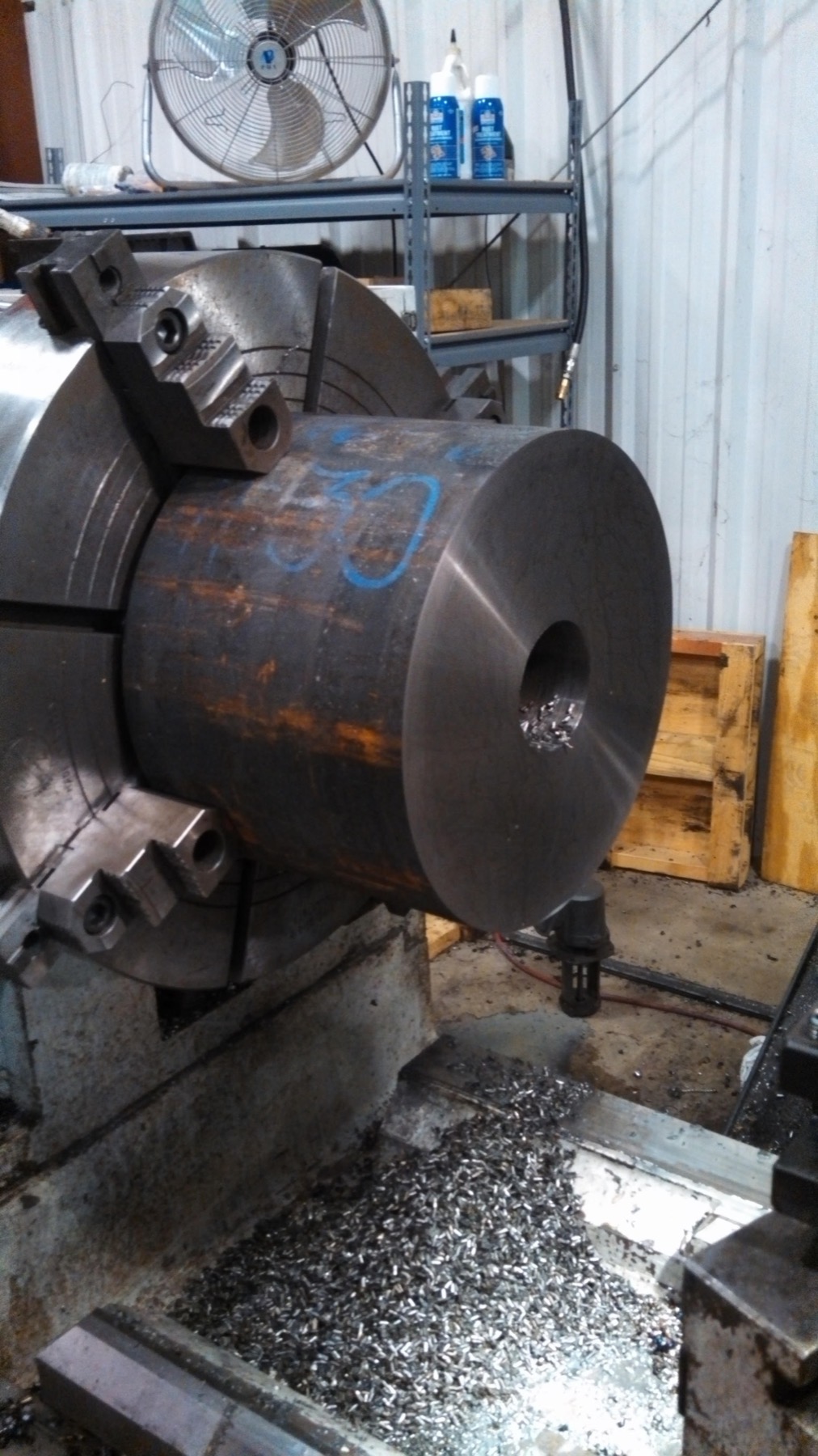 Custom cylinder head at the start of machining on a lathe