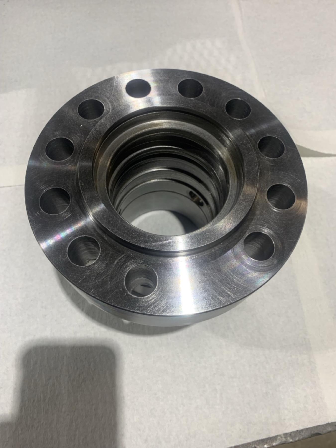 Newly machined hydraulic cylinder head with restored geometry and clean finish