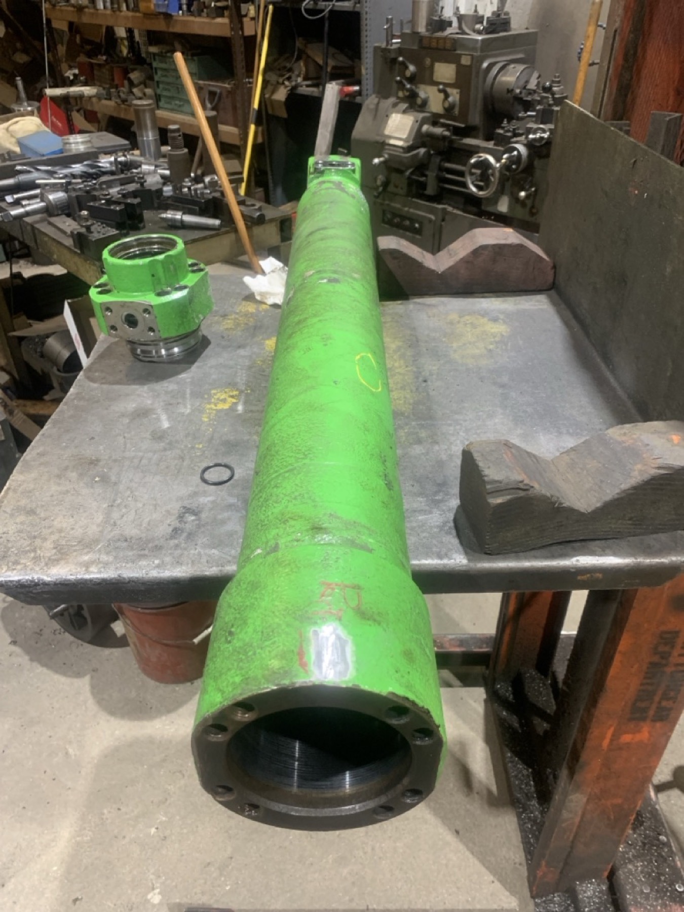 Damaged hydraulic cylinder base tube before repair and machining