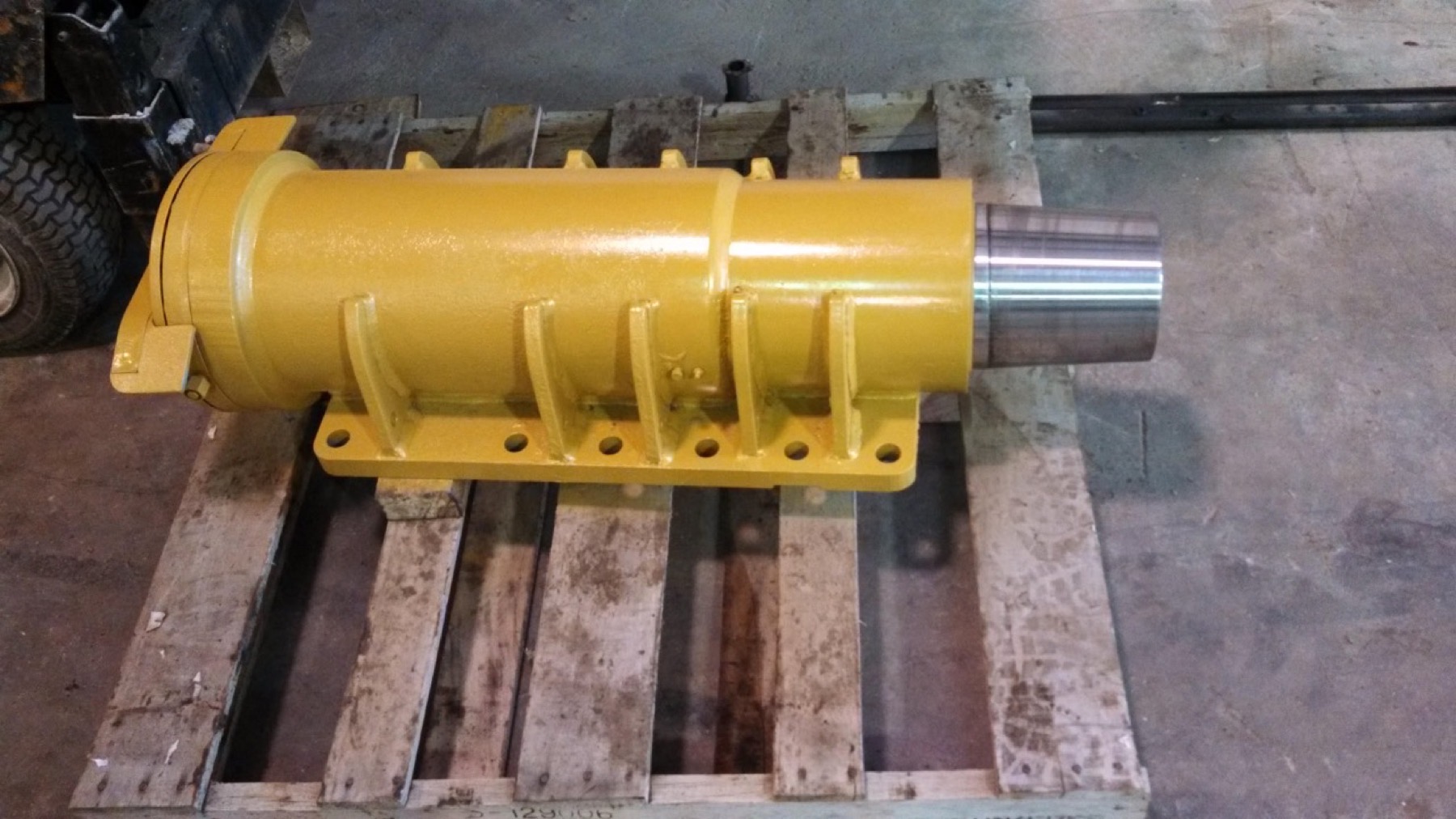 Completed rebuilt front strut hydraulic cylinder on pallet