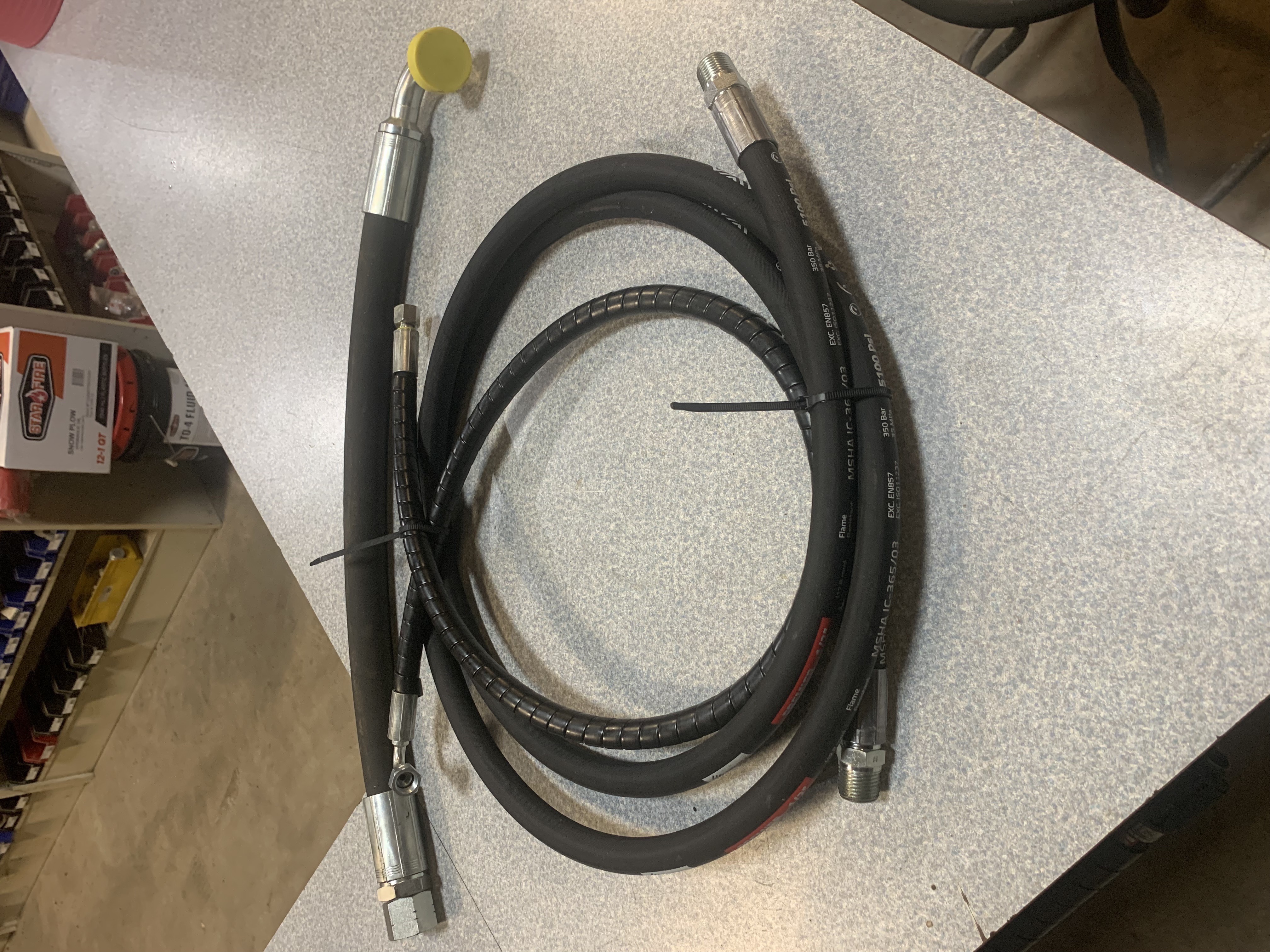 Recently assembled hydraulic hoses prepared on shop counter